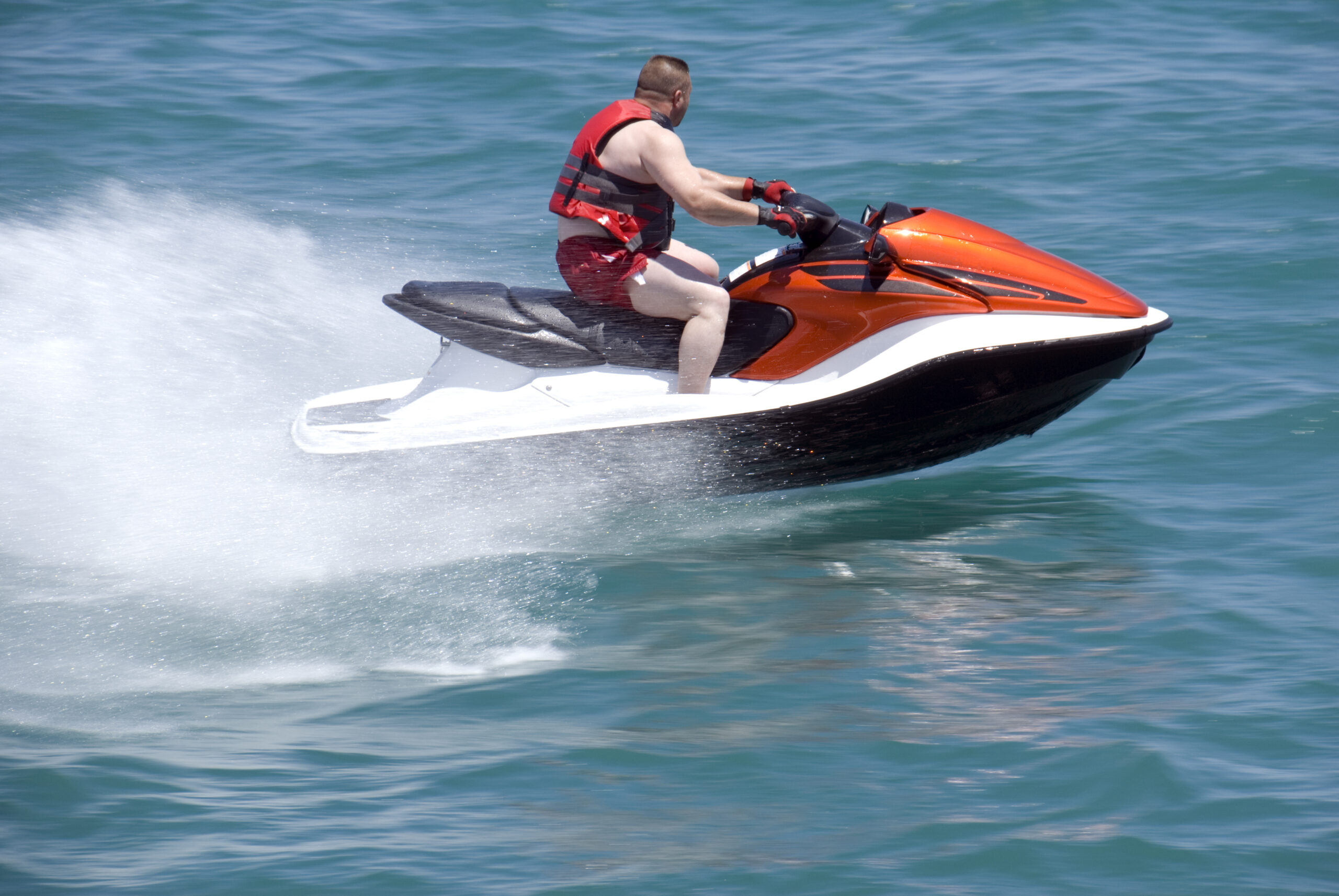 a-man-wearing-a-lifejacket-while-on-a-jet ski