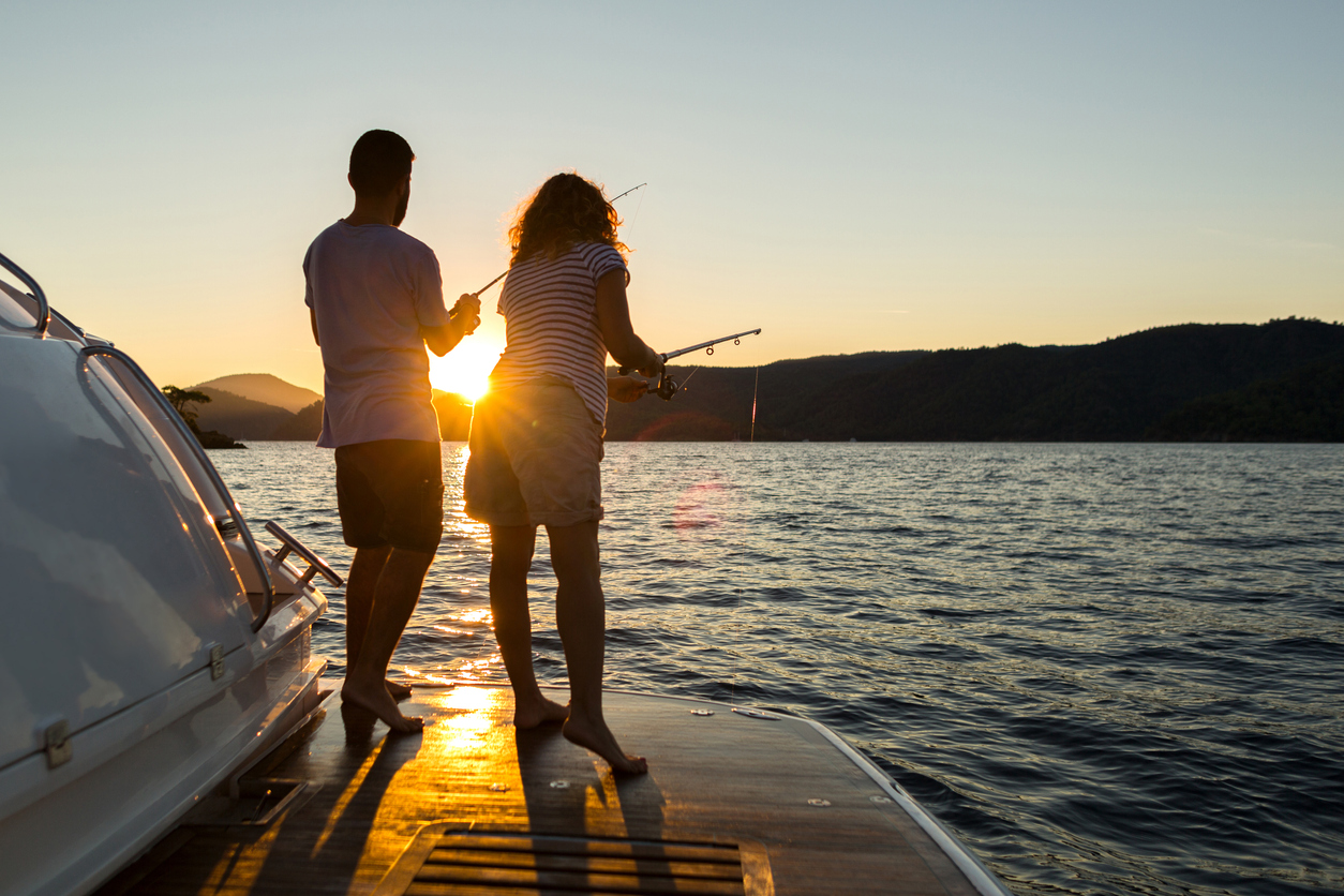 A young couple fishing at sunset