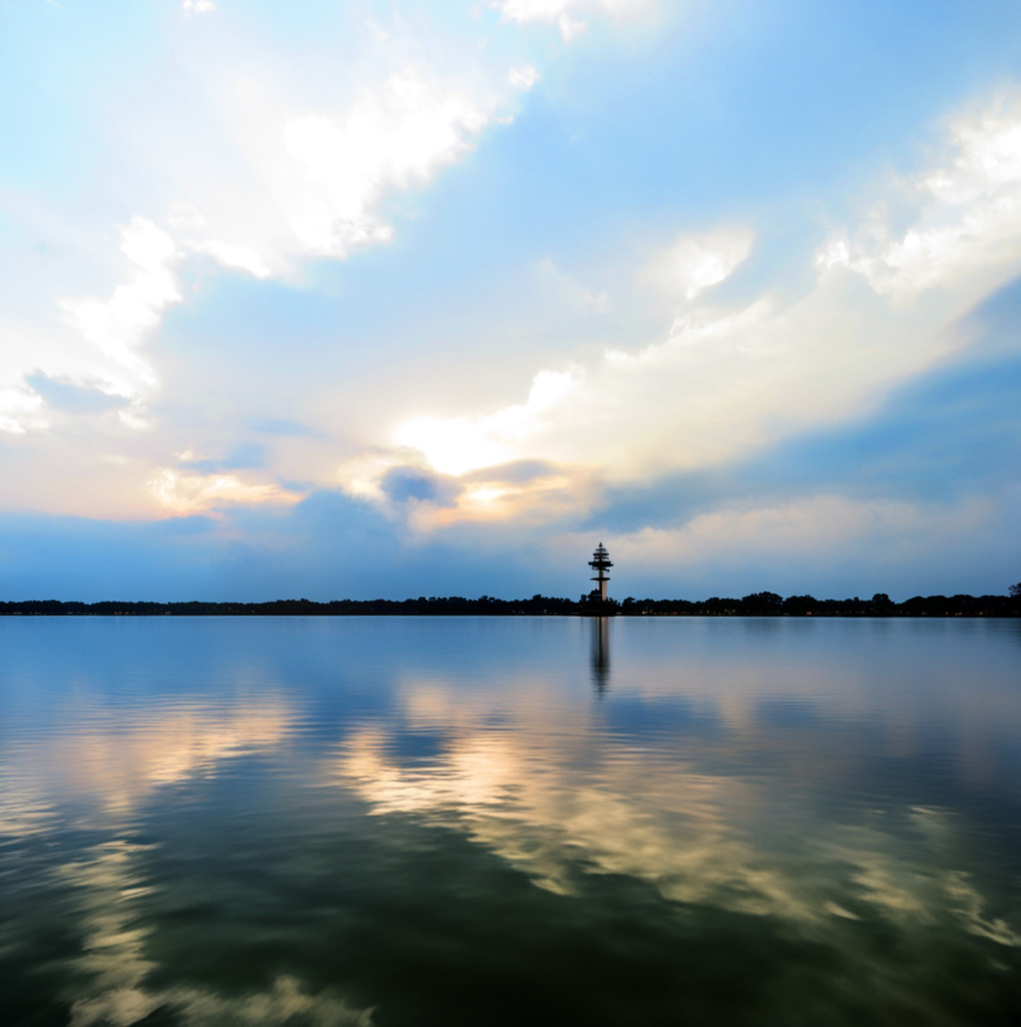The tranquil lake reflecting the cloudy sky at Lake Conroe, Texas