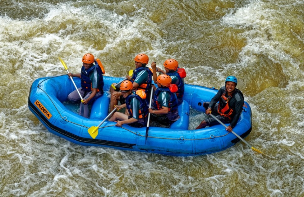 Paddling men in a raft