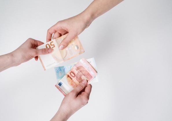 person holding 10 and 10 euro banknotes