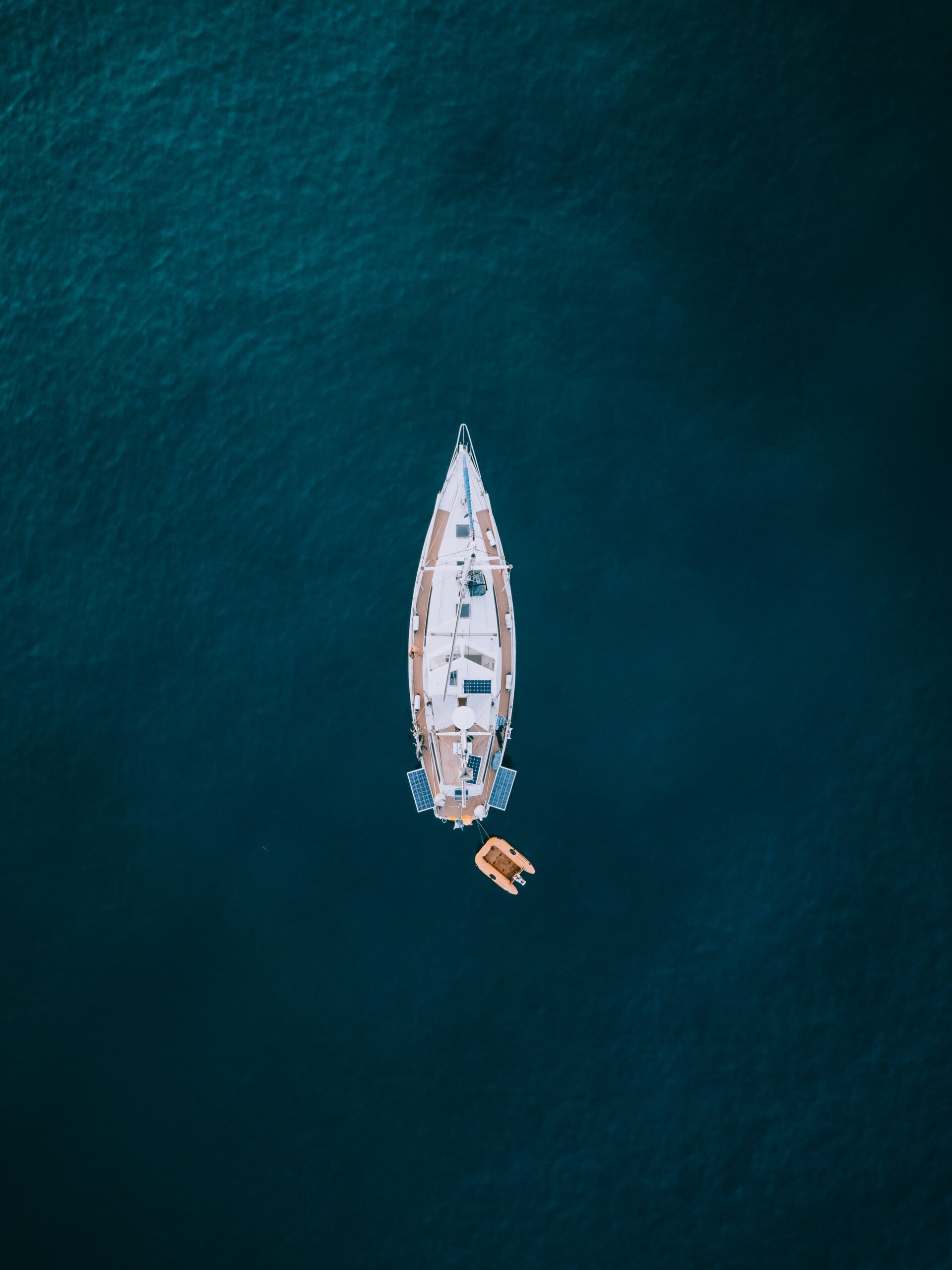 Aerial-photography-of-white-and-brown-boat-on-body-of-water
