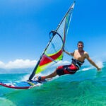 a-man-happily-windsurfing