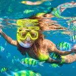 girl-in-snorkeling-mask-dive-underwater-with-coral-reef-fishes
