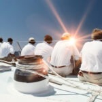 rear-view-of-sailing-crew-with-lens-flare