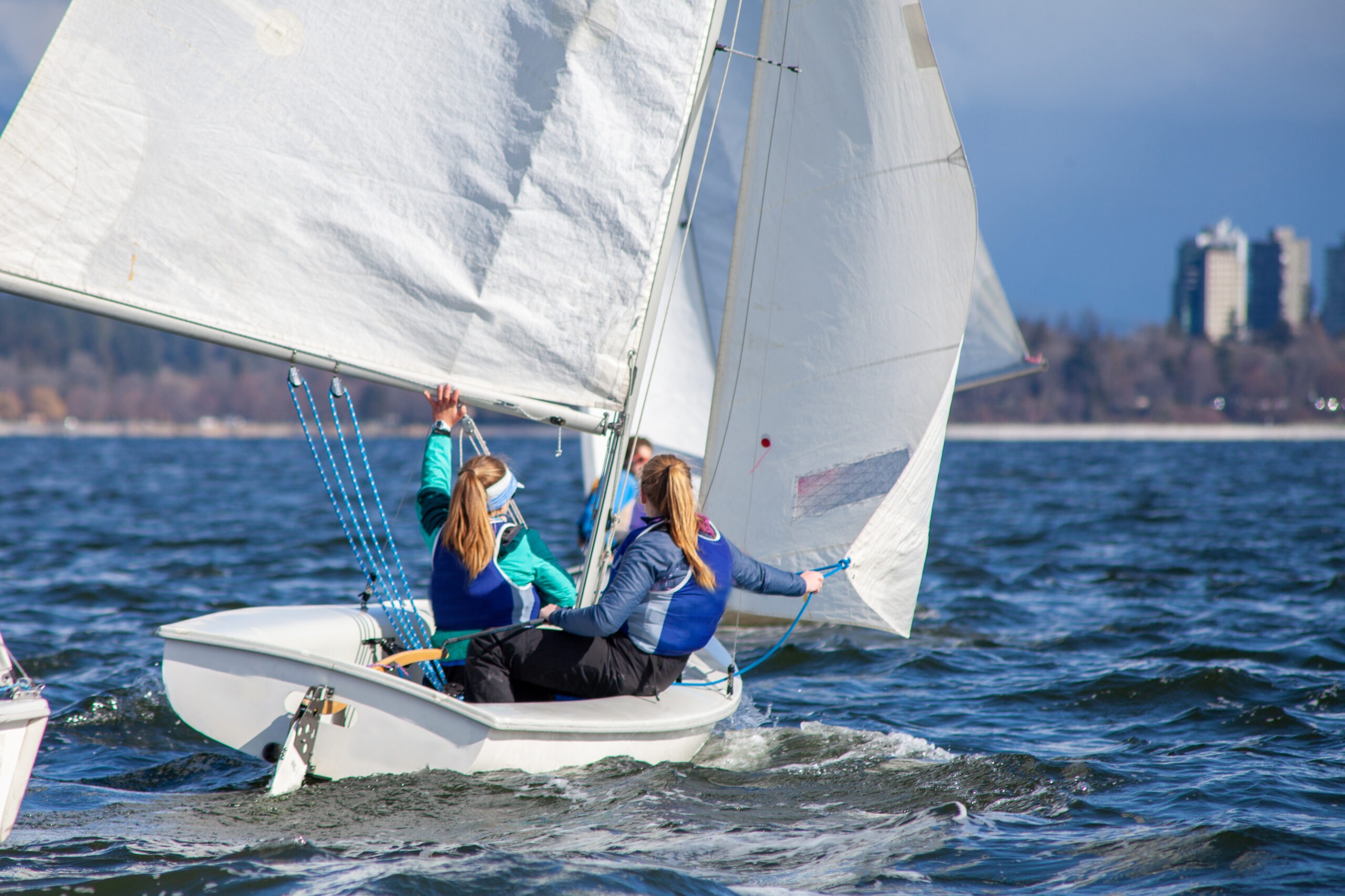 women-sailing-on-a-dinghy-boat