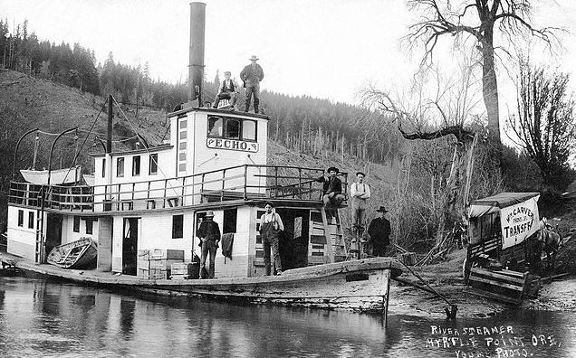 Echo-steamboat-men-standing-on-the-steamboat-tall-trees