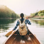 a-girl-with-a-backpack-paddling-a-canoe