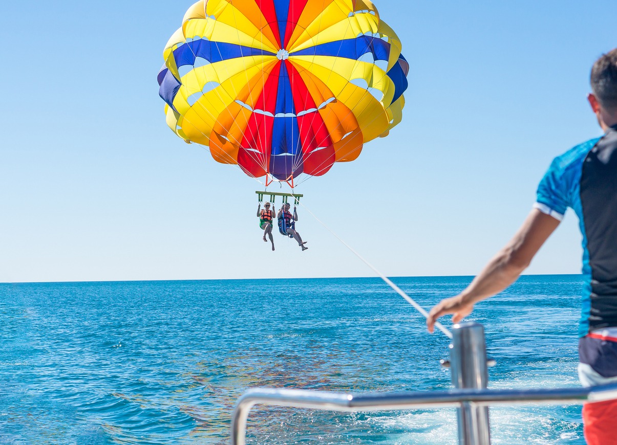 a-happy-couple-parasailing-in-mid-air