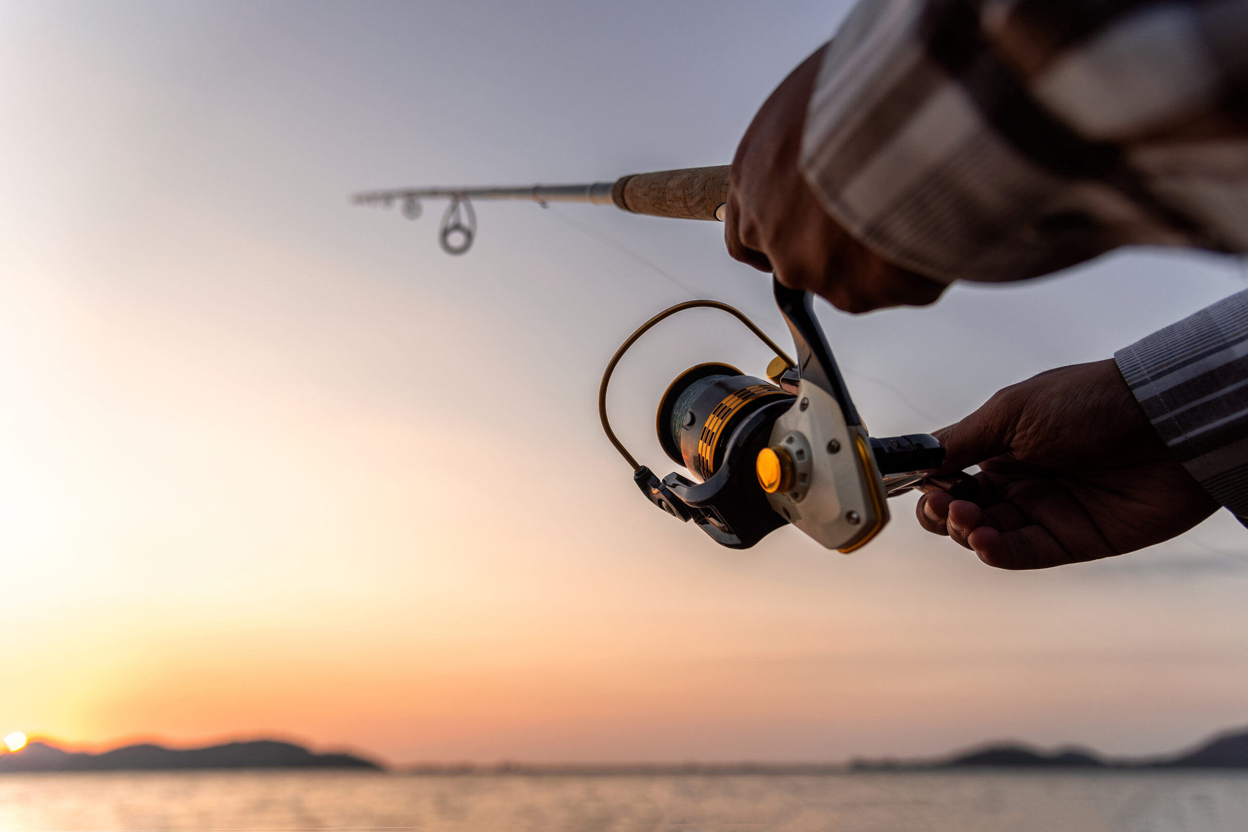 a-man-fishing-on-the-lake-at-sunset