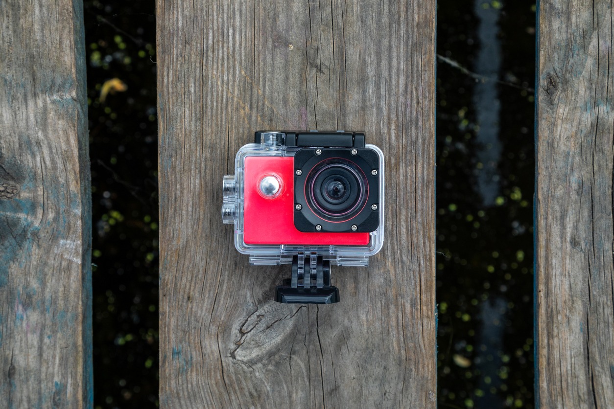 action-camera-in-a-protective-box-on-a-wooden-background