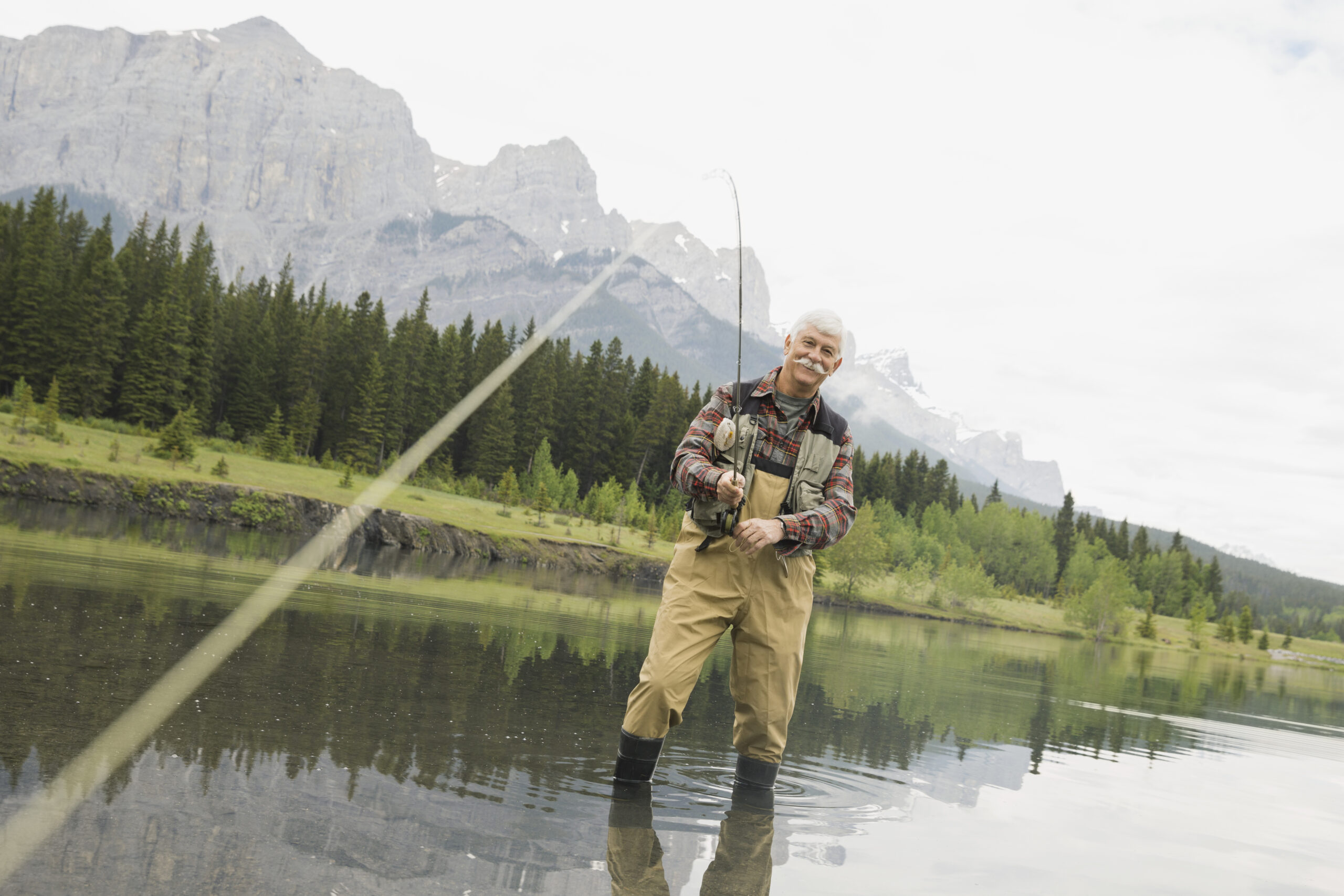 older-man-fishing-in-still-lake